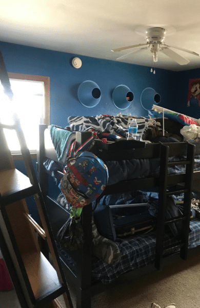 Before picture of Preston and Kiptons room with dark blue and bunked beds.