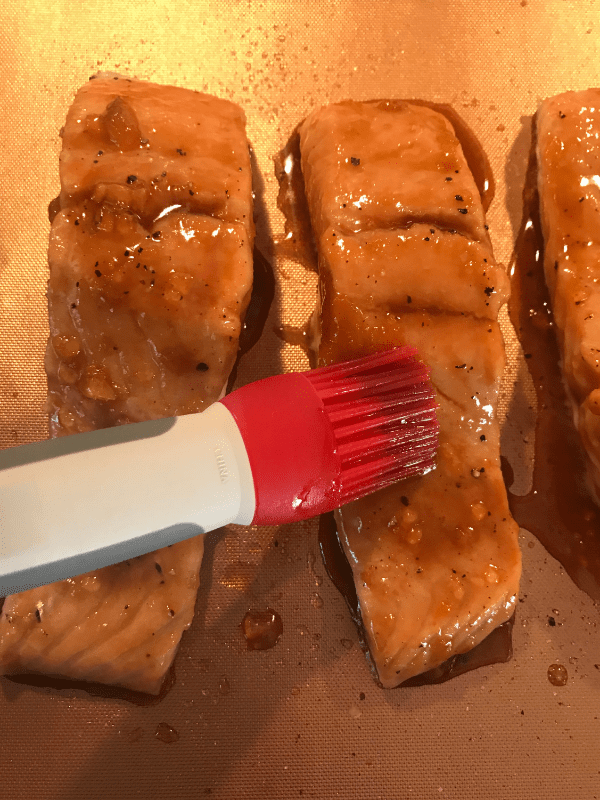 Use a basting brush to coat the salmon with the apricot glaze.