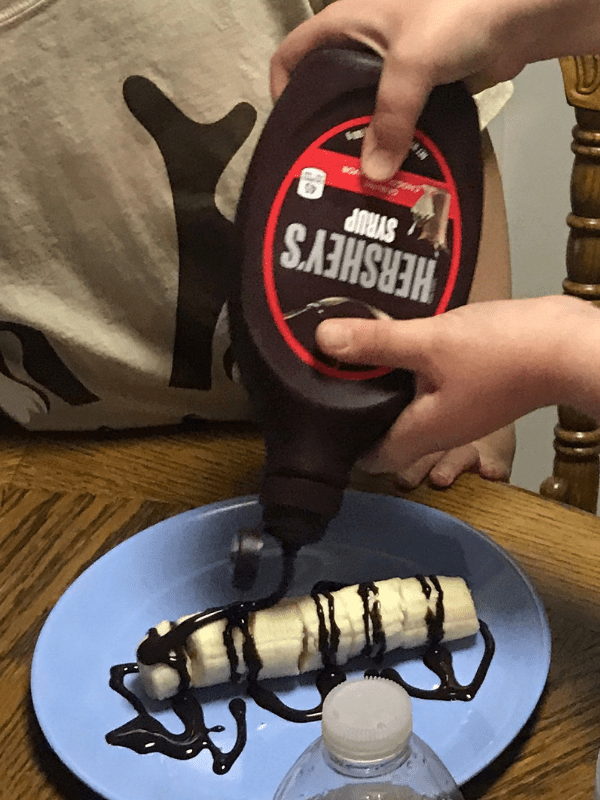 My daughter's creation: Chocolate syrup over bananas.