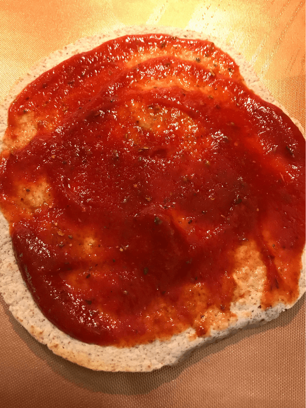 Spread the pizza sauce on a crispy tortilla.